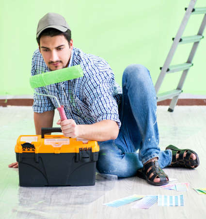 Young man doing home renovationの写真素材