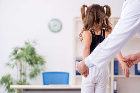 Small girl visiting young male doctorの写真素材