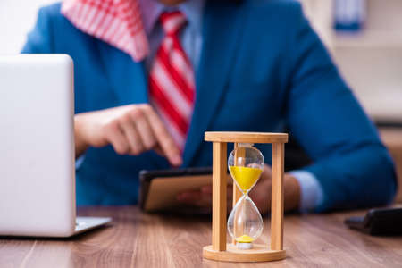 Young male arab employee working in office