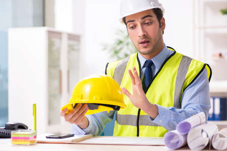 Young male architect working in the office