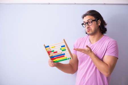 Young male student in front of board