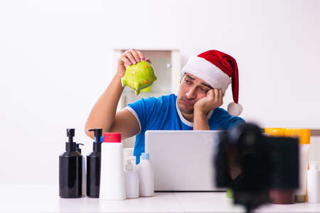 Young male sales consultant recording video for his blogの写真素材