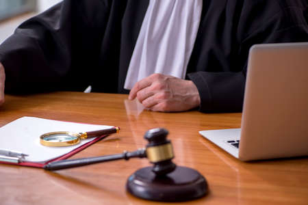 Old male judge working in courthouse