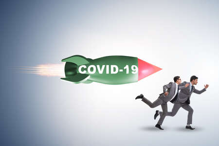 Concept of covid crisis with businessman chased by rocketの写真素材