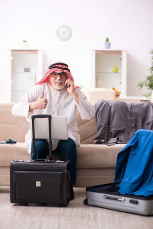 Old arab businessman preparing for business tripの写真素材