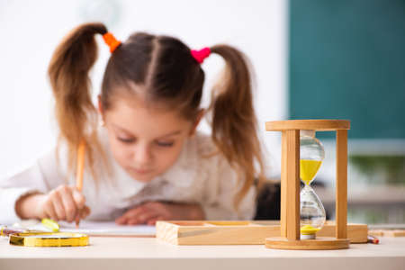 Small girl in time management conceptの写真素材
