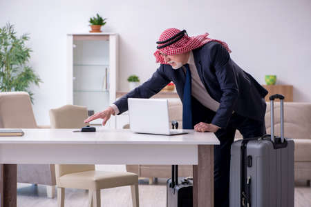 Old arab businessman preparing for business tripの写真素材