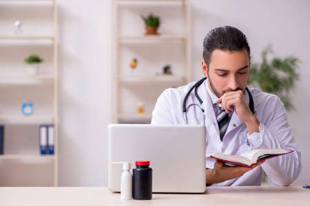 Young male doctor working in the clinicの写真素材