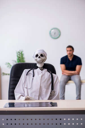 Young man visiting dead doctorの写真素材