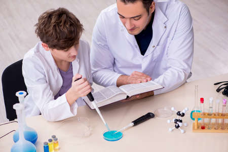 Young father and son chemists in the lab