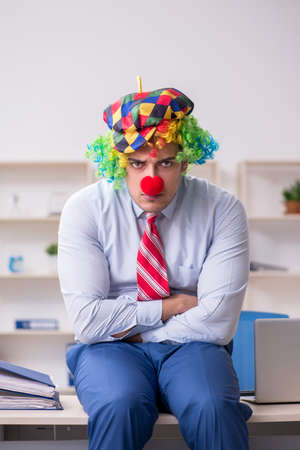 Funny employee clown working in the officeの写真素材