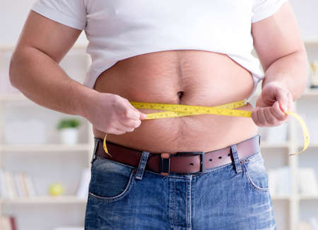 Fat obese man in dieting conceptの写真素材
