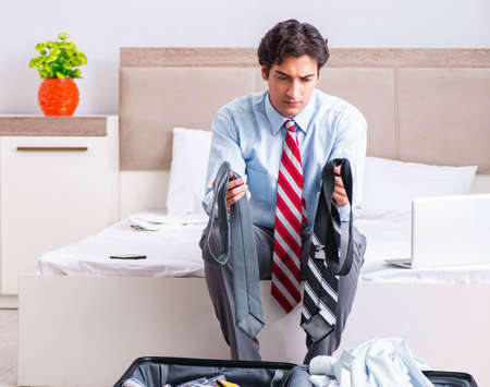 Young handsome businessman preparing for tripの写真素材