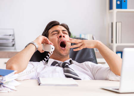 Young call center operator speaking on phoneの写真素材