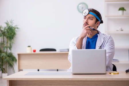 Young male doctor working in the clinicの写真素材