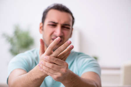 Injured young man suffering at homeの写真素材