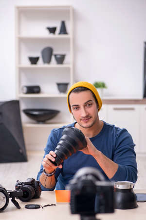 Young male photographer recording video for his blogの写真素材