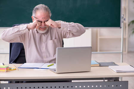 Old male teacher in the classroomの写真素材