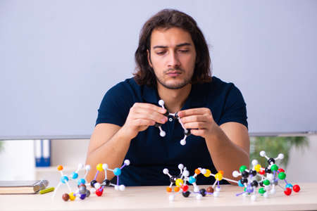 Young male scientist sitting in the classroomの写真素材