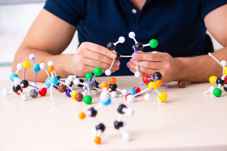 Young male scientist sitting in the classroomの写真素材