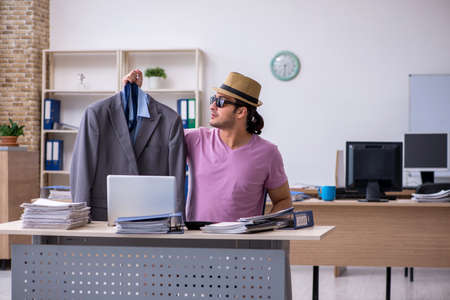 Young male employee preparing for the tripの写真素材