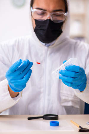 Male expert criminologist working in the lab for evidenceの写真素材