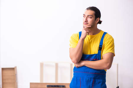 Young male carpenter working indoorsの写真素材