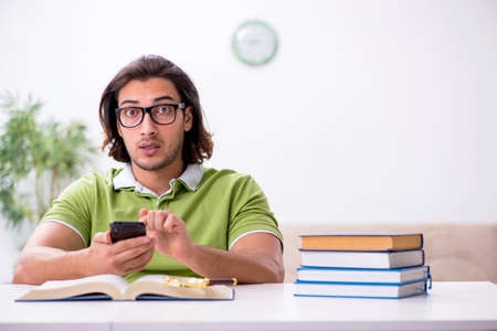 Young male student preparing for exams at homeの写真素材