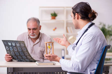Male patient visiting doctor radiologist in time management concの写真素材