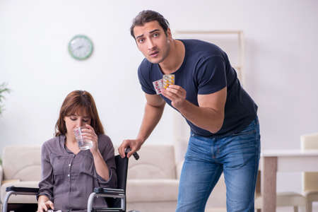 Disabled wife and young husband at homeの写真素材