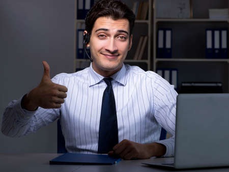 Call center operator talking to customer during night shift