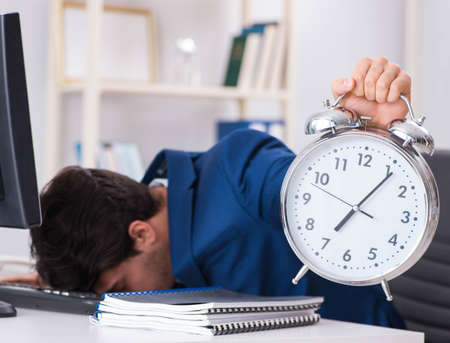 Businessman employee in urgency and deadline concept with alarm