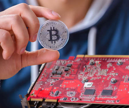 Young man mining bitcoins at home