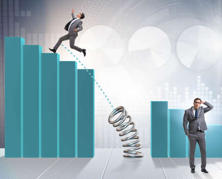 Business people jumping over bar chartsの写真素材