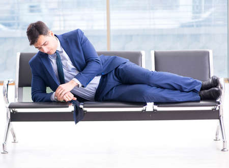 Businessman waiting at the airport for his plane in business claの写真素材