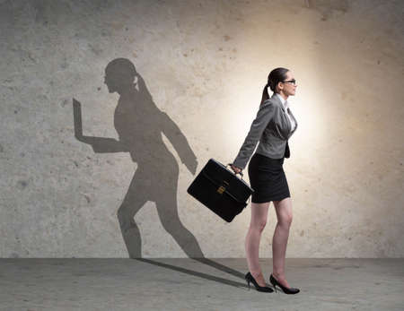 Businesswoman and his shadow in business conceptの写真素材
