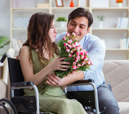 Man making marriage proposal to disabled woman on wheelchairの写真素材