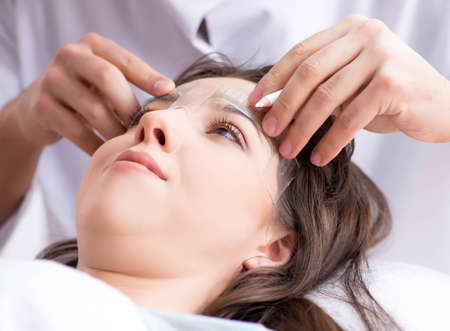 Doctor measuring patients face before plastic surgeryの写真素材