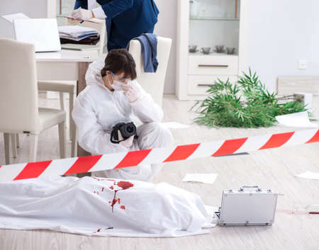 Forensics investigator at the scene of office crimeの写真素材