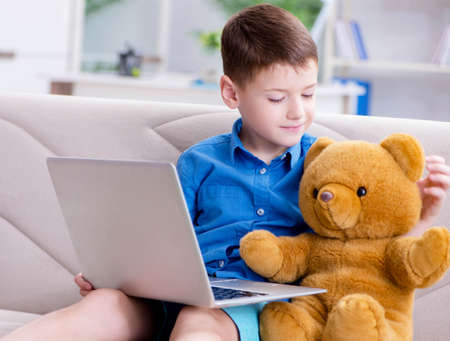 Little boy surfing internet on laptopの写真素材