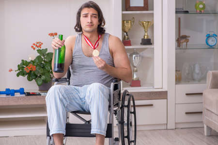 Man ex-champion in wheel-chair suffering from alcoholismの写真素材