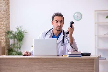 Young male doctor working in the clinicの写真素材