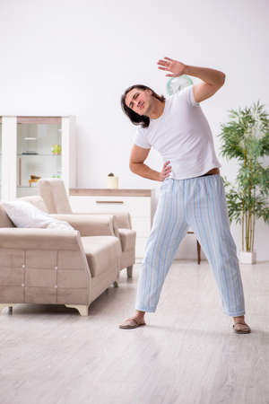 Young male starting day with morning exercisesの写真素材