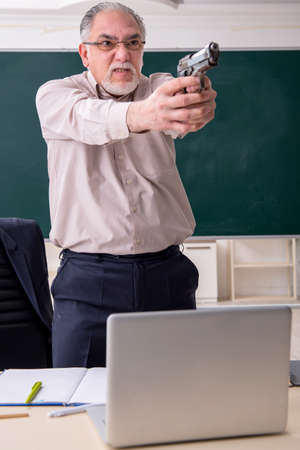 Old male teacher in the classroomの写真素材