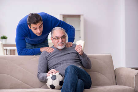 Father and son watching soccer on tvの写真素材