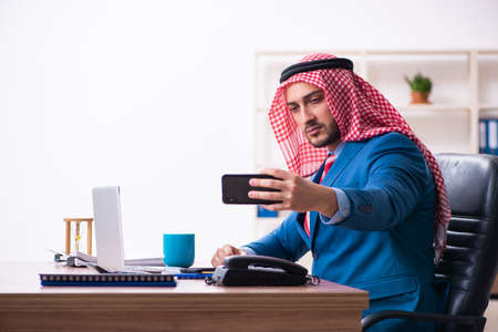 Young male arab employee working in officeの写真素材