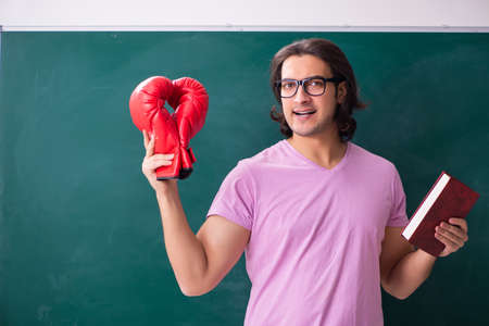Young male student in front of boardの写真素材