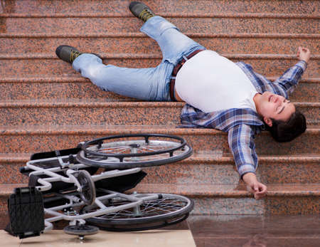 Disabled man on wheelchair having trouble with stairs