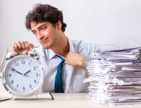 Overloaded busy employee with too much work and paperworkの写真素材