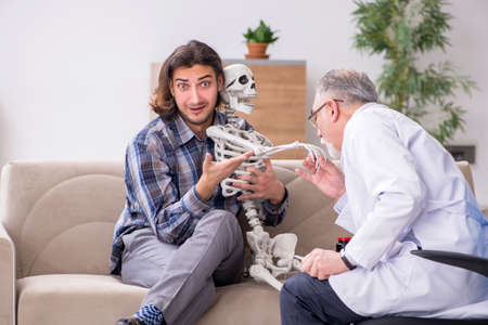 Young male patient visiting experienced doctor psychiatristの写真素材